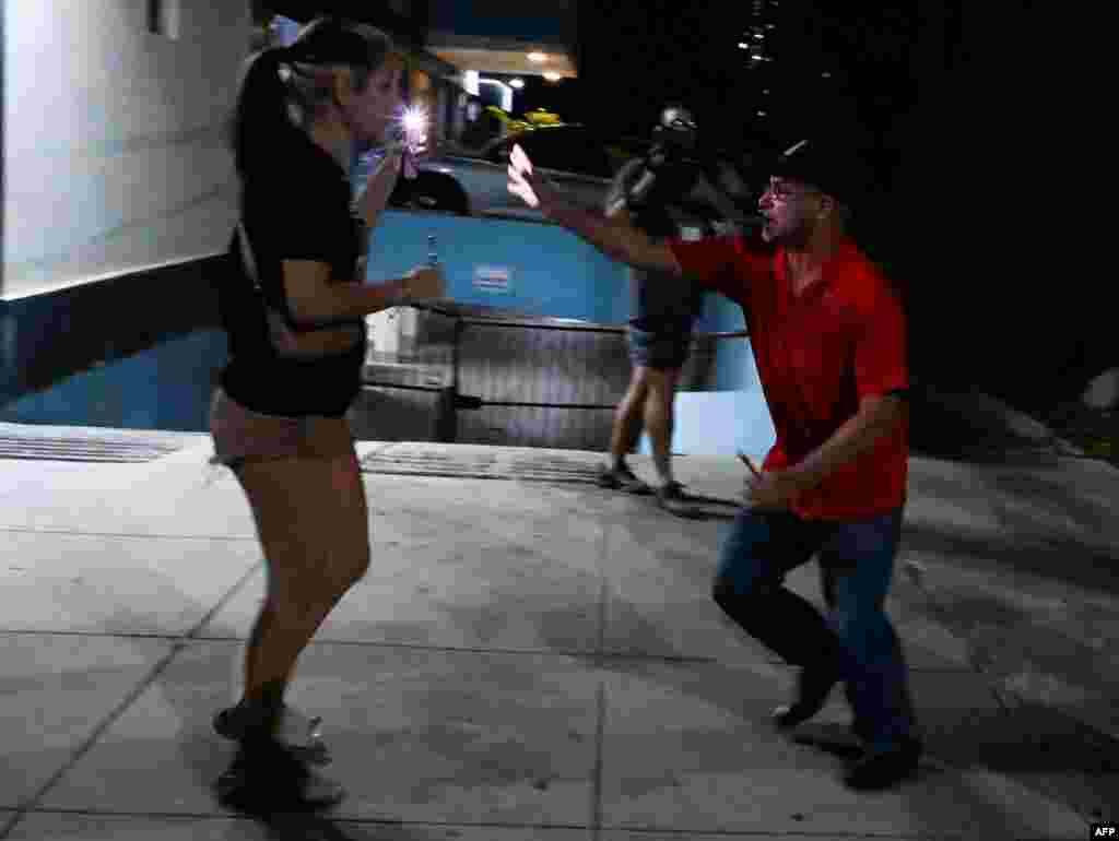 Un agente vestido de civil detiene a un a joven manifestante durante las protestas del sábado, 1ro de octubre, en El Vedado, La Habana. (YAMIL LAGE / AFP)