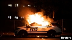 Un carro patrullero incediado por los manifestantes.