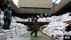 Un grupo de trabajadores desvela varios contenedores ocultos entre sacos de azúcar y que presumiblemente contienen material bélico, dentro del barco norcoreano Chong Chon Gang hoy, martes 16 de julio de 2013, en el muelle de Manzanillo en Colón (Panamá). 