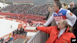 El presidente ruso, Vladimir Putin, y el ministro de deportes de Rusia, Vitaly Mutko, observan una competición de esquí alpino de los Juegos Paralímpicos de Invierno de 2014, en Sochi. (Alexei Nikolsky, Sputnik vía AP)