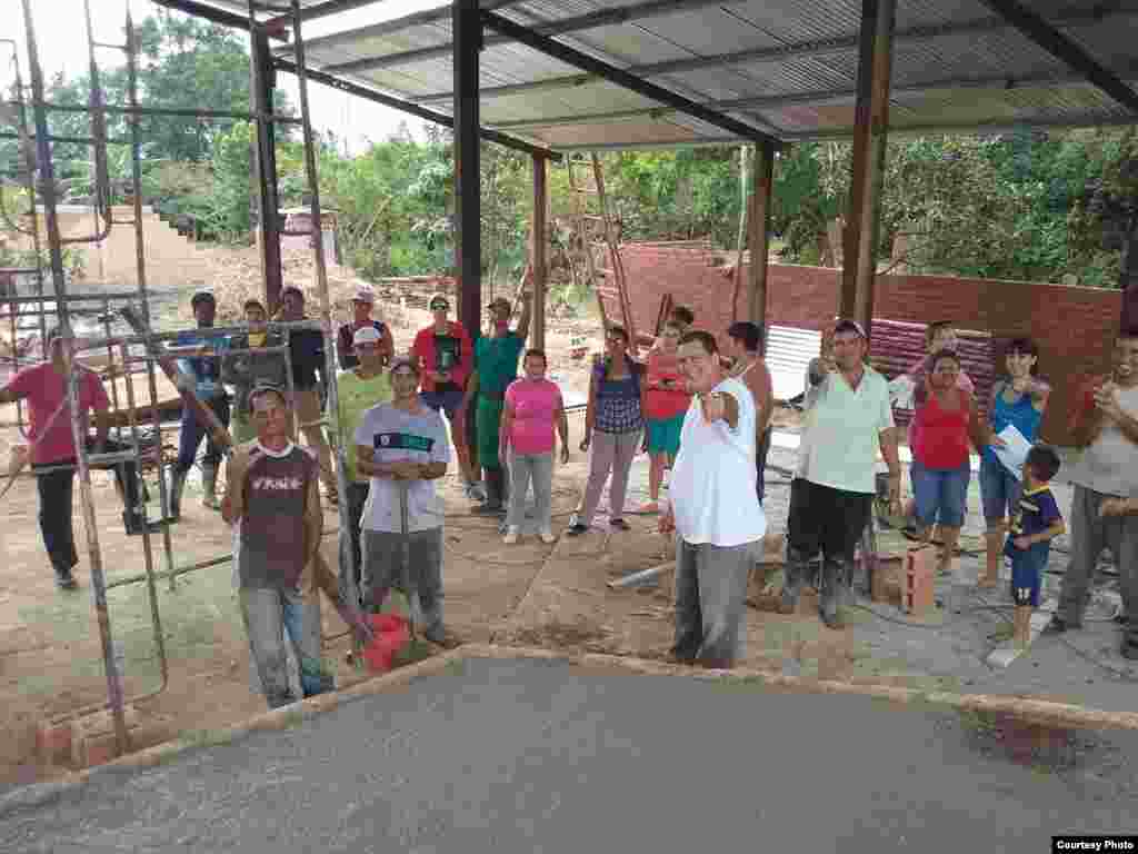 El pastor Bernardo de Quesada (al frente) con los feligreses que trabajan en la construcción del techo para el lugar de culto en Camagüey.