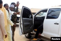 Oficiales de seguridad y civiles junto al auto donde secuestraron a los médicos cubanos en Mandera, Kenia (Foto: Archivo).