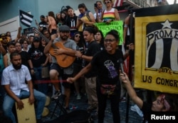 Miembros del grupo de teatro Papel Machete actúan durante la protesta de este lunes en San Juan.