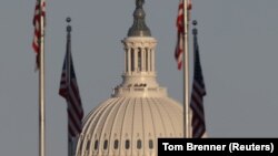 US National Guard soldiers look out at the National Mall from an observation deck at the US Capitol