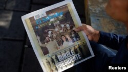 Un hombre sostiene un periódico que dice "Presidente Bukele" tras las elecciones presidenciales, en San Salvador, El Salvador, 5 de febrero de 2024. REUTERS/José Cabezas