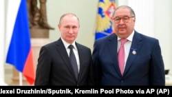 Vladimir Putin junto a Alisher Usmanov en 2017.