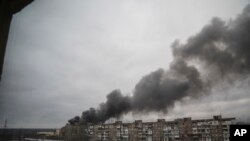 Una nube de humo sale de un edificio después de un bombardeo de las fuerzas rusas en la ciudad portuaria de Mariúpol, Ucrania.(AP/Evgeniy Maloletka)