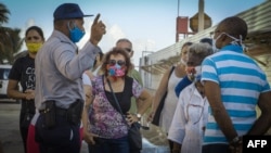 Un policía organiza una cola en La Habana (Adalberto Roque/AFP).